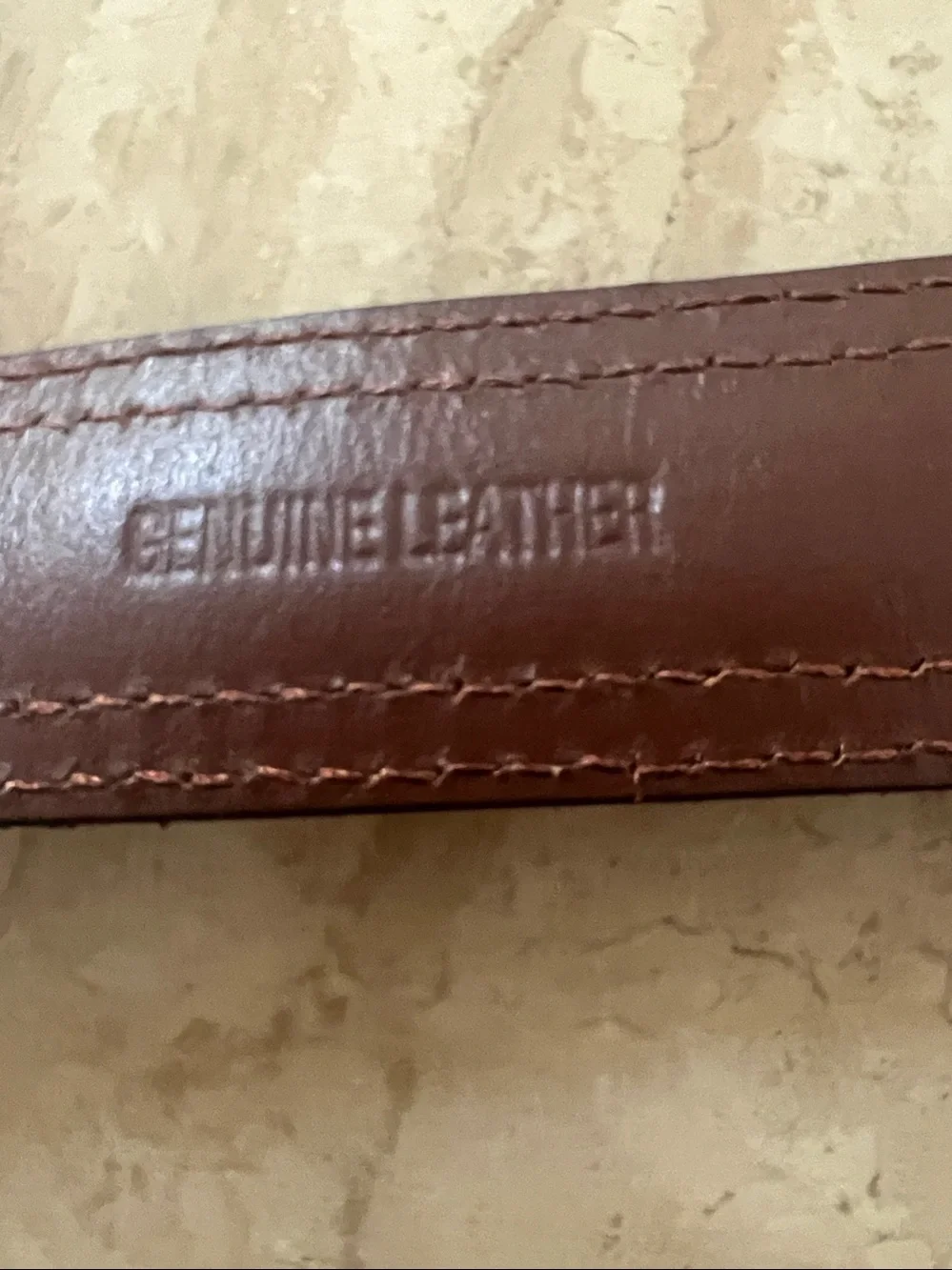 Nautica men's belt featuring brown leather,blue canvas inlay, brass buckle